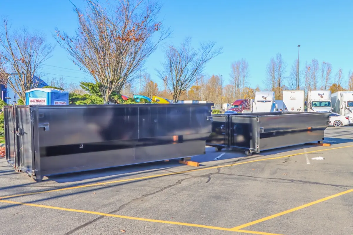 Professional dumpster rental service with roll-off container on residential driveway in St. Charles